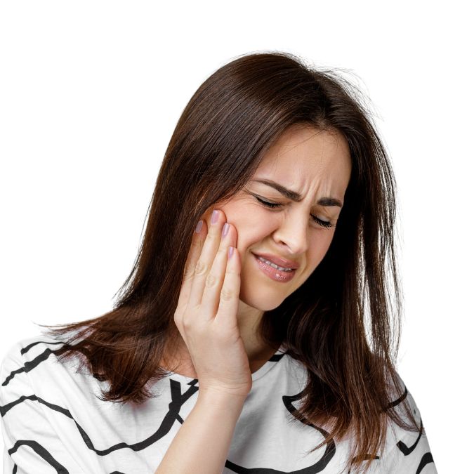 Woman grimacing in pain and holding her cheek from tooth pain.