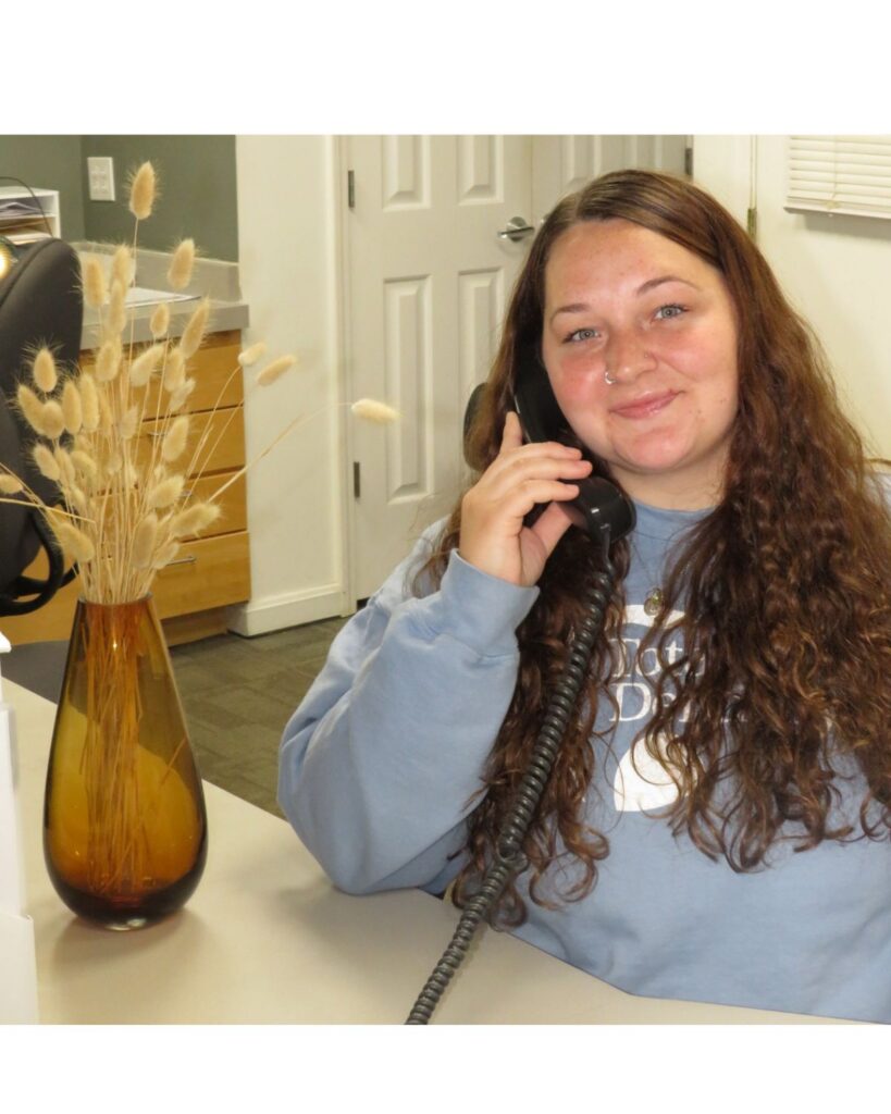 Receptionist answering a patient call at Total Dentistry in Cincinnati.