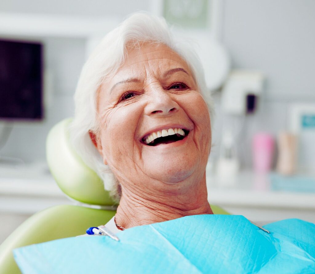 Patient smiling after experiencing Total Dentistry